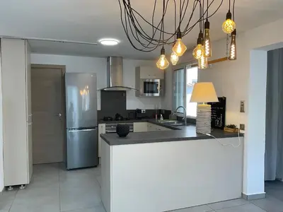 a kitchen with a refrigerator and a counter top at VILLA OCEANE in San-Nicolao
