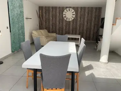 a dining room with a white table and chairs at VILLA OCEANE in San-Nicolao