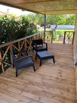 a porch with two chairs and a bench on it at L ASCOSU in Ventiseri