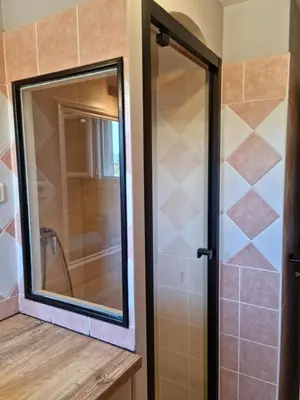 a bathroom with a mirror and a shower at L'ortu di Quaprice in Figari