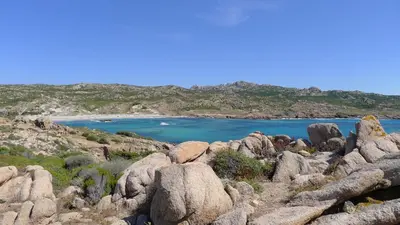 a view of a beach with rocks and water at L'ortu di Quaprice in Figari