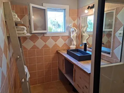 a bathroom with a sink and a mirror at L'ortu di Quaprice in Figari