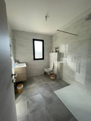 a bathroom with a shower and a toilet and a sink at Superbe T3 NEUF VUE MER in Propriano