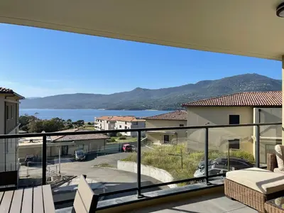 a view of the water from the balcony of a house at Superbe T3 NEUF VUE MER in Propriano