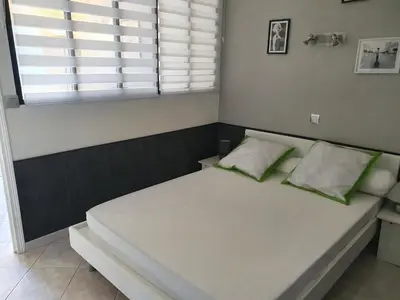 a bed with two pillows on it in a room at Villa les palmiers -Stretta di i mandarini in Lucciana