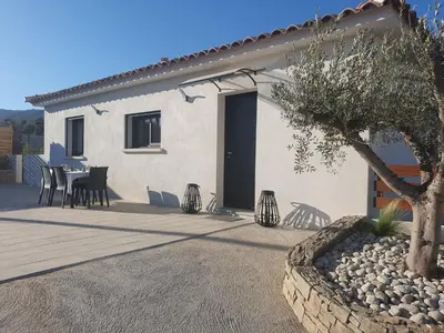 a house with a table and chairs in front of it at Villa l'alivu in Afa
