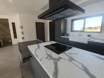a kitchen with a marble counter top and a sink at Villa l'alivu in Afa