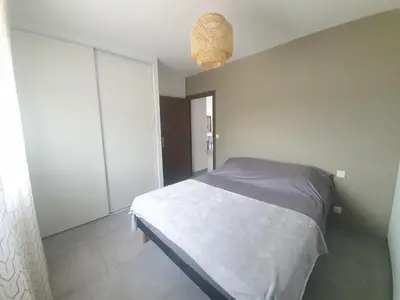 a bedroom with a white bed and a window at Villa l'alivu in Afa