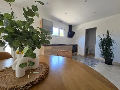 a dining room table with two white vases with plants on it at Domaine U Filanciu - Centru di Corsica in Moltifao