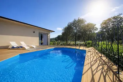 a swimming pool in the backyard of a house at Domaine U Filanciu - Centru di Corsica in Moltifao