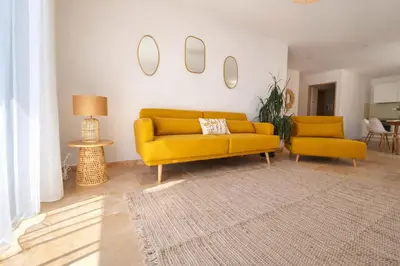 a living room with a yellow couch and two chairs at Domaine U Filanciu - Centru di Corsica in Moltifao