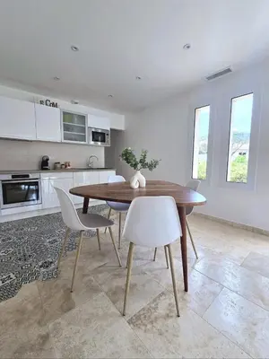 a kitchen and dining room with a wooden table and chairs at Domaine U Filanciu - Centru di Corsica in Moltifao