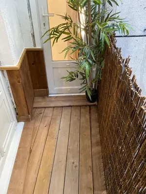 a hallway with a door and a fence and plants at F2 Glamour Centre ville historique in Ajaccio