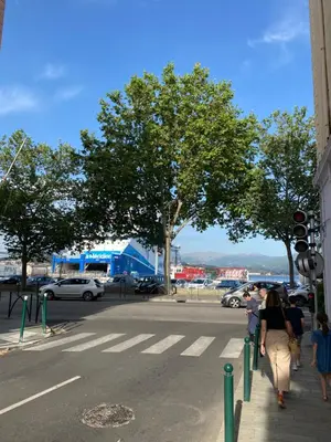 a group of people walking down a city street at F2 Glamour Centre ville historique in Ajaccio