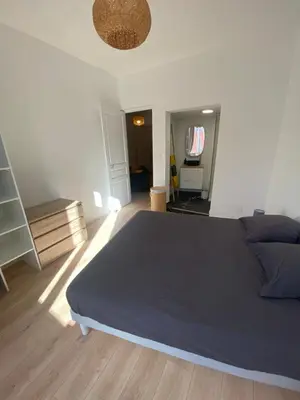 a bedroom with a large blue bed in a room at F2 Glamour Centre ville historique in Ajaccio