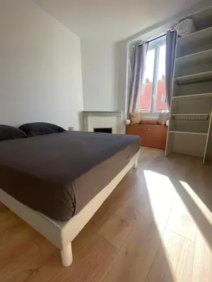 a bedroom with a large bed and a window at F2 Glamour Centre ville historique in Ajaccio