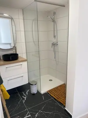 a shower with a glass door in a bathroom at F2 Glamour Centre ville historique in Ajaccio