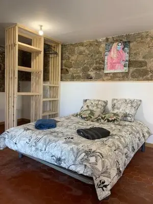 a bedroom with a bed in a room at Chez LULU appartement de caractère in Cozzano