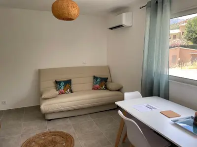 a living room with a couch and a table at Les jardins de Saint Pancrace in Corte