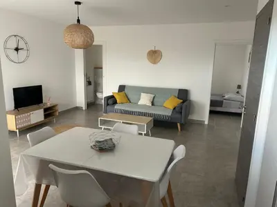 a living room with a table and a couch at Les jardins de Saint Pancrace in Corte