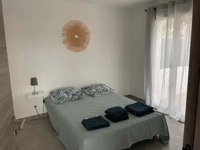 a bedroom with a bed with two pillows on it at Les jardins de Saint Pancrace in Corte