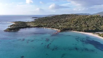 an aerial view of an island in the ocean at Cala Rossa, Pinarello, Saint Cyprien - La Villa D'Alice in Lecci