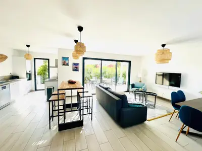 a living room with a couch and a table at Cala Rossa, Pinarello, Saint Cyprien - La Villa D'Alice in Lecci