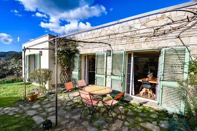 a patio with a table and chairs in front of a building at Villa Anastasia in Zilia