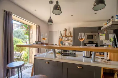 a kitchen with two glasses of wine on a counter at Villa Anastasia in Zilia