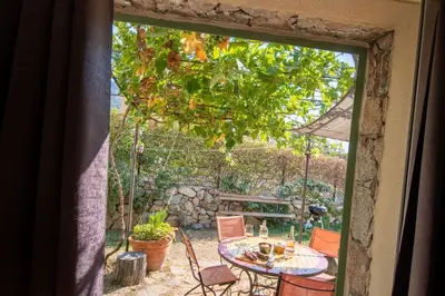 a window view of a patio with a table and chairs at Villa Anastasia in Zilia