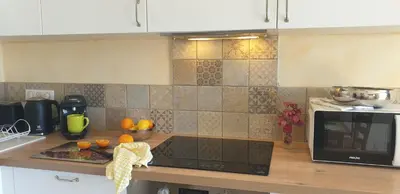 a kitchen with a counter with oranges on it at Appartement A Caserella entièrement rénové avec terrasse et vue panoramique sur mer in Valle-di-Campoloro