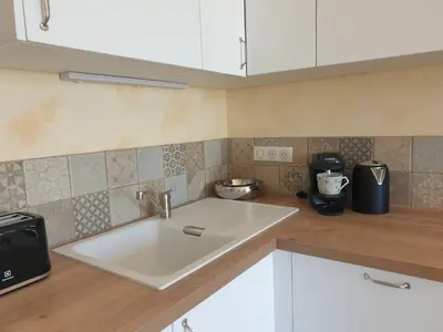 a kitchen with a sink and a counter top at Appartement A Caserella entièrement rénové avec terrasse et vue panoramique sur mer in Valle-di-Campoloro