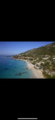 a view of a beach with houses and the ocean at Ajaccio magnifique T2 37m2 centre ville vue mer au bord de la plage Neuf 4 couchages balcon parking privé fermé Clim wifi in Ajaccio