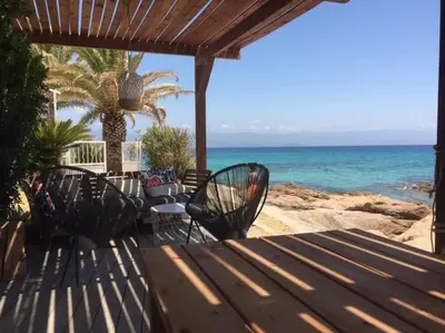 two chairs and a table on a patio overlooking the ocean at Ajaccio magnifique T2 37m2 centre ville vue mer au bord de la plage Neuf 4 couchages balcon parking privé fermé Clim wifi in Ajaccio