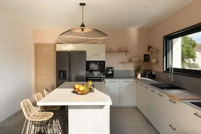 a kitchen with a island with a bowl of fruit on it at Villa Asphodede in Lecci