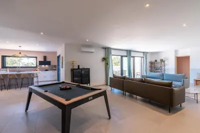 a living room with a ping pong table in it at Villa Asphodede in Lecci