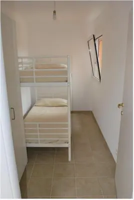 a small room with bunk beds and a staircase at Residence Conca Blue in Conca