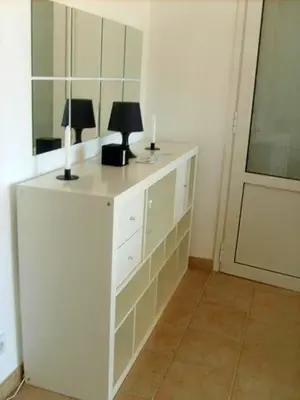 a white cabinet with two lamps on it in a room at Residence Conca Blue in Conca