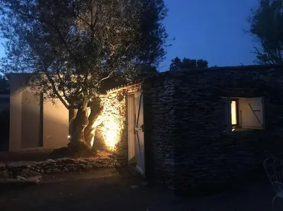 a building with a tree in front of it at night at Petite Bergerie in Bonifacio