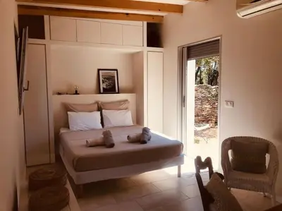 a bedroom with a bed with two teddy bears on it at Petite Bergerie in Bonifacio