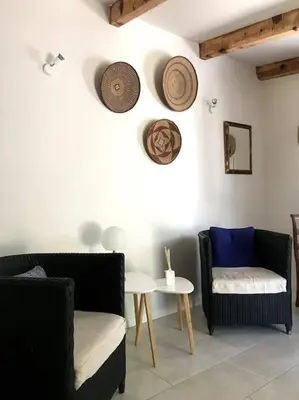 a living room with two chairs and a table at Petite Bergerie in Bonifacio