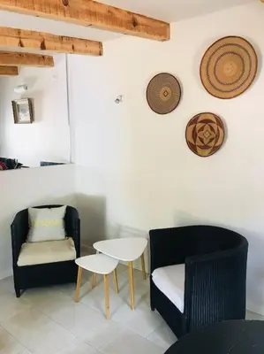 a living room with two chairs and a table at Petite Bergerie in Bonifacio