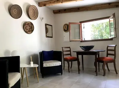 a room with chairs and a table and a window at Petite Bergerie in Bonifacio
