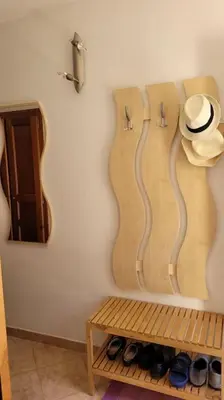 a room with a hat and shoes on a wall at Maison avec piscine entre mer et montagne in Muro