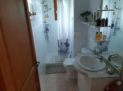 a bathroom with a sink and a shower and a toilet at Maison avec piscine entre mer et montagne in Muro