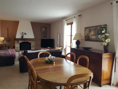 a living room with a table and a couch at Maison avec piscine entre mer et montagne in Muro