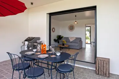 a dining room with a blue table and chairs at Tramontana quiet place 7 min from beach swimming pool bbq in Calenzana