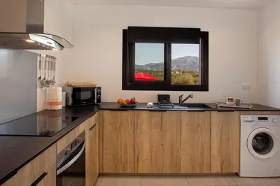 a kitchen with a sink and a window at Tramontana quiet place 7 min from beach swimming pool bbq in Calenzana