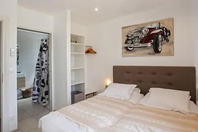 a bedroom with a bed with a motorcycle on the wall at apart Levante shared swimming pool bbq in Calenzana