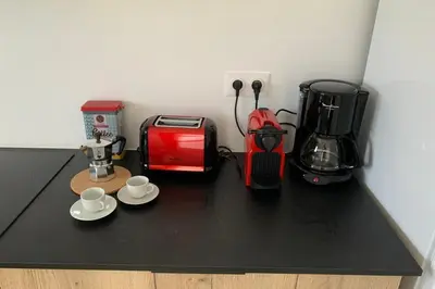 a counter top with a coffee maker and a toaster at appart Libeccio swimming pool bbq in Calenzana